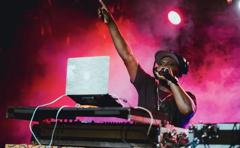 Un DJ lève le bras derrière ses platines, IZUBAFEST 2025